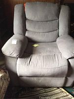 Front view of the gray electric recliner chair showing padded armrests, cushioned seat and backrest.