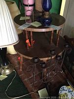 Full view of the two-tier round wooden table with items on it and surrounding it