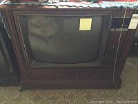 Front view of RCA console television showing CRT screen and wooden cabinet