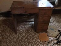 Desk closed, showing top surface and side drawers. Visible dings and scratches.