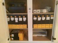 White cabinet shelf containing 10 black and yellow Kodak boxes labeled 1 to 10 containing slides titled 'Art Through the Ages'