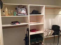 Closet shelves showing purses, scarves, hat box and some handbags