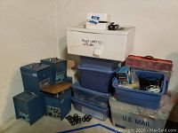 Five blue Lion spring gauges positioned near storage bins stacked and filled with electrical and mechanical accessories.