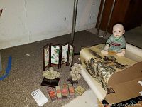 Overview of lot items including seated boy figurine, scroll, folding panel, name chops, and carved pieces.