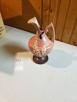 Front and side view of the Roseville Lilac pitcher showing floral details and two spouts.