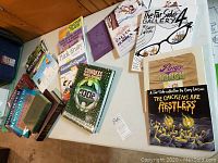 Overview of books spread on a table including Guinness World Records 2002 and various children's and adult books.