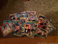 Photo of assorted baseball cards with colorful borders showing players from teams like Red Sox, Mariners, and Giants.