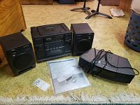 Sony CFD-440 CD-Radio-Cassette system with stereo speakers, manual visible on floor