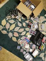 Overhead view of consoles, controllers, games on carpet