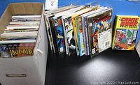 Cardboard box filled with over 130 comic books.