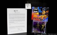 Photo of the Aero Strike Batman action figure sealed in original blister packaging with accompanying Certificate of Authenticity from George Barris estate.
