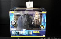 Front view of boxed Doctor Who River Song 5-inch action figure with Pandorica chair set in original packaging.