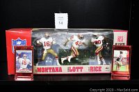 Front view of original box containing Joe Montana, Ronnie Lott, and Jerry Rice action figures in 49ers uniforms, plus two trading cards in plastic holders.