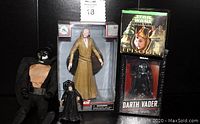Photo shows Supreme Leader Snoke Elite Series action figure in original box, a small Emperor Palpatine figure, Darth Vader black statue in box with quote book, and Naboo Trade Federation Droid Fighter figure.