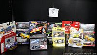 Photo of NASCAR die-cast cars and collectible Oreo Goodwrench tin with driver packaging.
