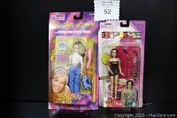 Photo of the lot showing two dolls in original packaging side by side, Britney Spears on the left and Spice Girls 'Posh' on the right.