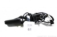 Black professional flat iron hair straightener with long cord coiled around the handle, showing the cord plug and control dial.