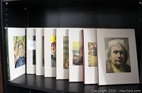 Eight volumes of Time-Life Library of Art in slipcases arranged on shelf, showing variety of cover art portraits and paintings.