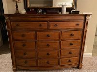 Full front view of chest showing convex bow front and fourteen drawers