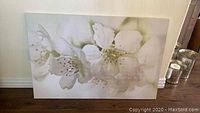 Large horizontal canvas showing white flower blossoms and part of the wooden floor