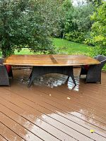 Full view of teak table on deck showing entire tabletop and base