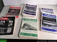 Stack of various 1980s train collector magazines including The Collector and Trains visible