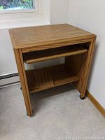 Front view of computer cart showing keyboard drawer and lower shelf.