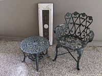 Photo showing the chair, side table, and wall decoration together giving overall view of the set and details