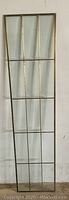 Full length view of the brass and beveled glass panel showing grid layout and overall shape.
