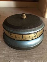 Side view showcasing the numeric dial and metal body of the timer clock.