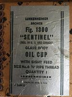 Photo of the original box with printed labeling describing the oil cup as Lunkenheimer Bronze Fig. 1300 Sentinel Glass Body Oil Cup.