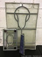 Three stained and leaded glass pieces arranged together: two panels and one smaller decorative glass shard.