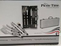 Box front showing image of BBQ tools set inside aluminum case and branding Picnic Time.