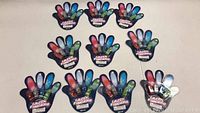 Ten Lazer Fingers branded toy packages shaped like a hand with colorful finger illustrations arranged on a flat surface.