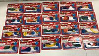 Lot of 20 packages of new balloon helicopter toys laid out in rows showing the front packaging.