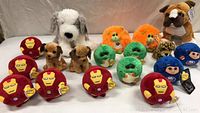 Image showing the full group of 18 brand new kids stuffed animals with tags, various characters including Iron Man, dogs, orange lions, green turtles, and blue superhero figures.