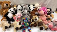 Photo showing the lot of 22 stuffed animals including pandas, pigs, koala, teddy bears, lamb, and multicolored bear.