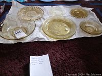 Full view of amber serving dishes and plate set with note detailing quantity
