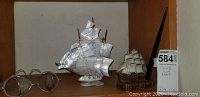 Overall lot showing large ship decor with mother of pearl sails, smaller wooden ship, and vintage eyeglasses.