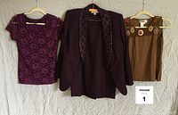 Photo of three garments: purple wool suit jacket with detachable beaded collar, sleeveless brown crochet top, and purple lace short sleeve top.