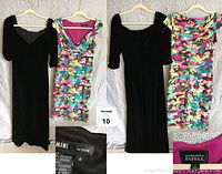 Two women's dresses hanging on hangers against a white textured background. Black velvet dress on the left and colorful printed dress on the right. Labels visible showing size and brand details.