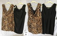 Front and back views of two dresses, one leopard print and one black, hanging on hangers.