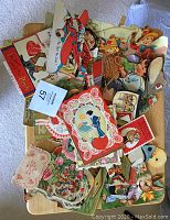 Pile of colorful vintage valentines from 1920s-1930s, showing multiple die-cut cards with varied themes including a red airplane and children.