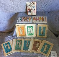 View of all 14 sewing patterns displayed on a couch showing both 1960s and 1980s patterns.