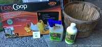 Full lot showing Cozy Coop heater box, two unopened spray bottles of chicken coop cleaner, and empty wooden basket.