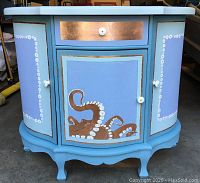 Front view of painted cabinet with drawer and doors closed