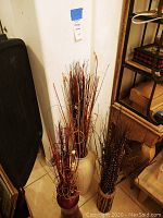 Front angle showing all three vases grouped together with dried floral accents inside them.