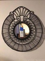 Full front view showing the entire wired frame and mirror reflection.