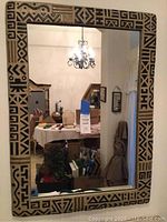 Front view of the rectangular Aztec decorative mirror showing the full frame and reflection.