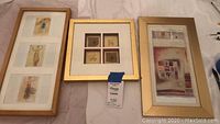 Three framed artworks laid out side by side on a white surface, showing the wooden frame with dancing ladies on left, the gold frame with leaf decor in the center, and gold-framed beach decor on right.